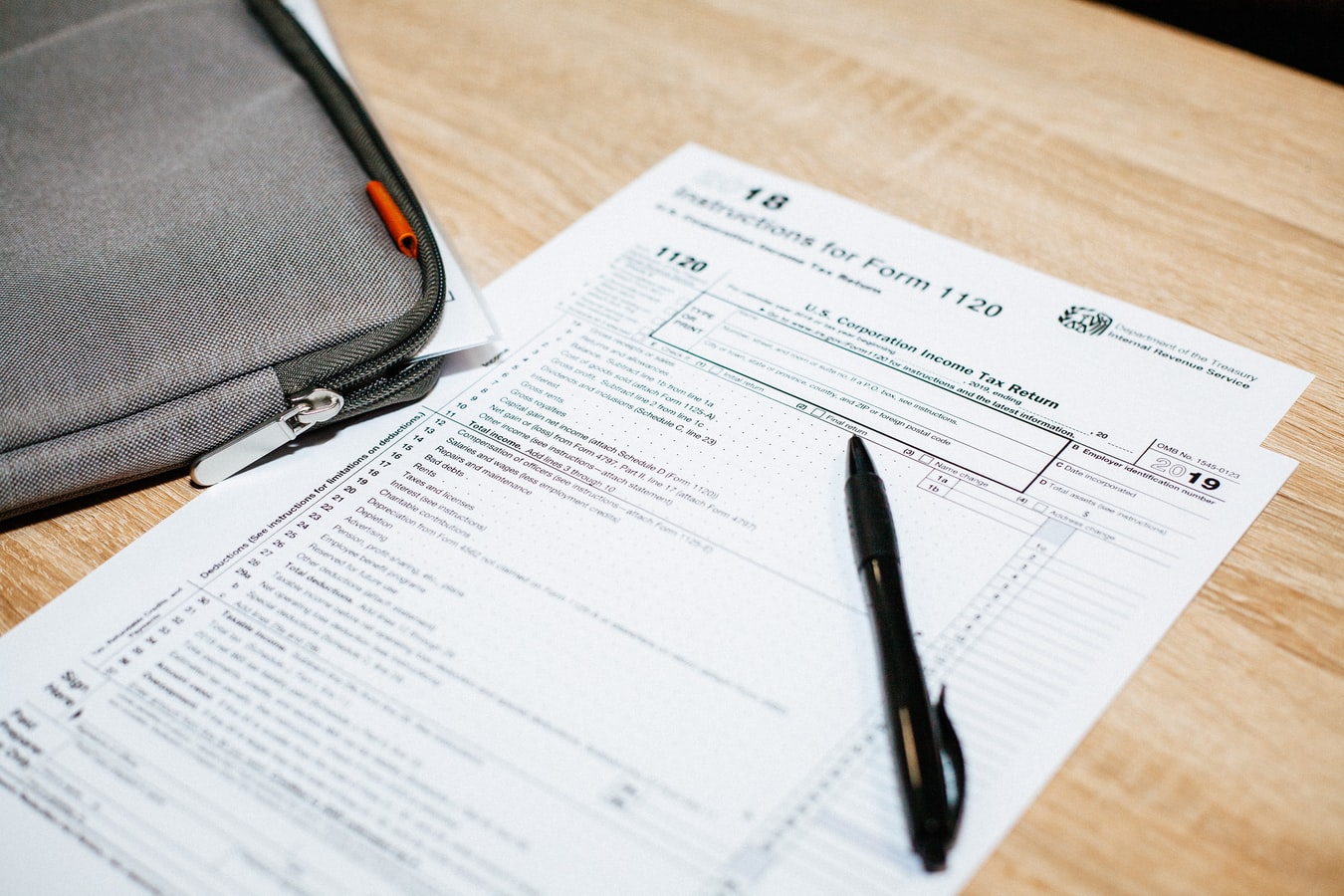 A Bag, a Document, and a Pen Placed on the Table